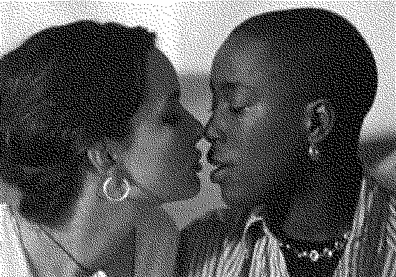 Black and white pixelated image of a white woman with long tied in a bun about to kiss a black woman with a buzzcut and striped button up shirt, from the movie The Watermelon Woman